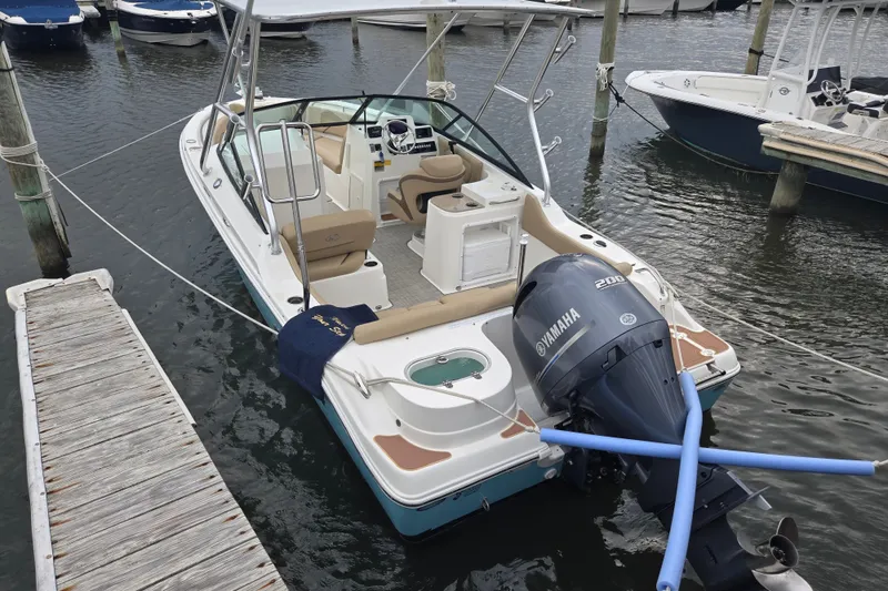 Slide: The Image of 2020 NauticStar 2302 Legacy Dual Console boat docked with Yamaha engine. - 5