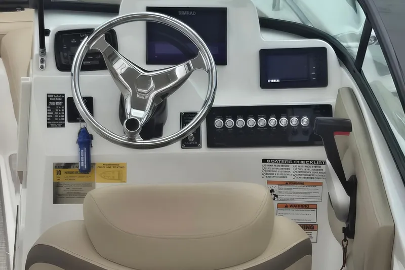 Slide: The Image of 2020 NauticStar 2302 Legacy Dual Console helm with steering wheel and control panel. - 2
