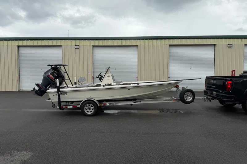 Slide: The Image of 2020 Hewes Redfisher 18 boat on trailer, parked outside storage units. - 13
