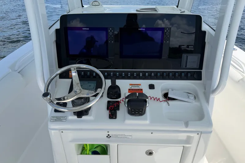 Slide: The Image of 2019 Sea Hunt Gamefish 30 helm with dual Simrad displays and modern controls. - 14