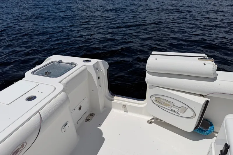 Slide: The Image of 2019 Sea Hunt Gamefish 30 boat deck with ocean view, featuring storage compartments and seating. - 29