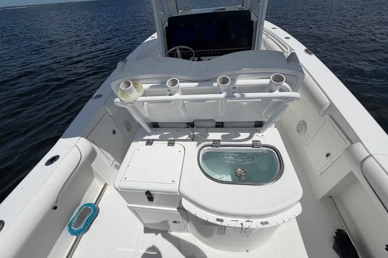 Slide: The Image of 2019 Sea Hunt Gamefish 30 boat interior with fishing rod holders and livewell. - 18