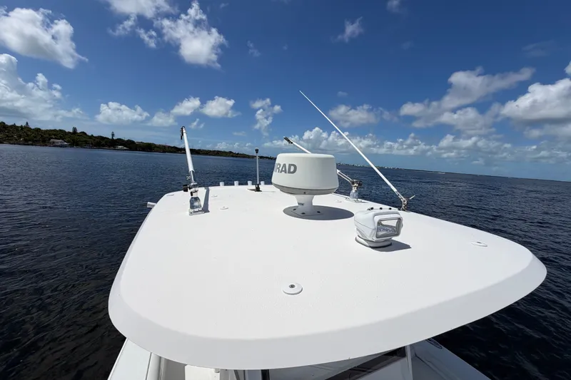 Slide: The Image of 2019 Sea Hunt Gamefish 30 boat on open water under a clear blue sky. - 33