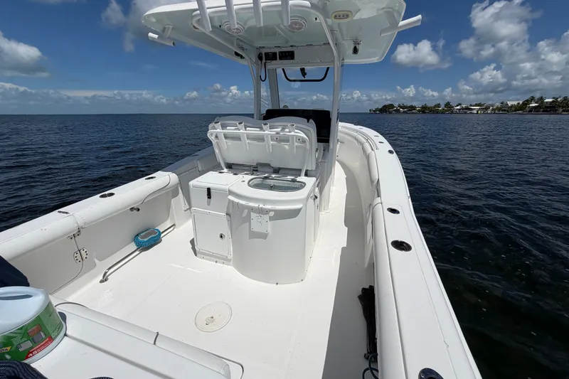 Slide: The Image of 2019 Sea Hunt Gamefish 30 boat on open water under a clear blue sky. - 19