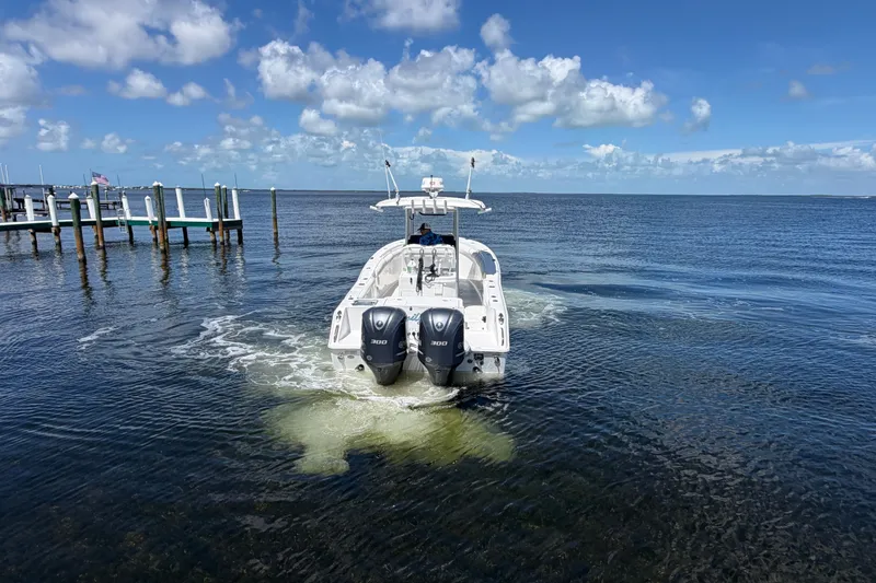 Slide: The Image of 2019 Sea Hunt Gamefish 30 boat cruising on open water under a clear blue sky. - 13