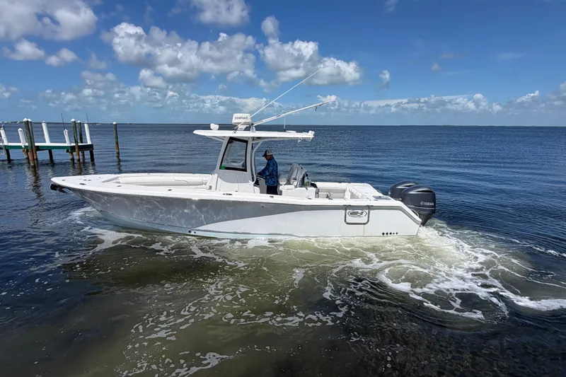 The Image of 2019 Sea Hunt Gamefish 30 boat cruising on calm ocean waters under a clear sky. - 0