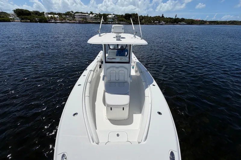 Slide: The Image of 2019 Sea Hunt Gamefish 30 boat on calm water under a clear sky. - 21