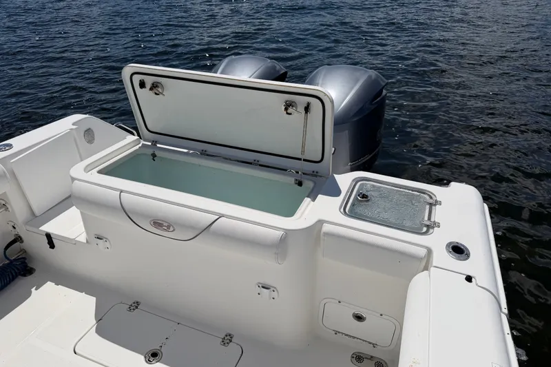 Slide: The Image of 2019 Sea Hunt Gamefish 30 boat with open storage compartment and dual engines on water. - 28