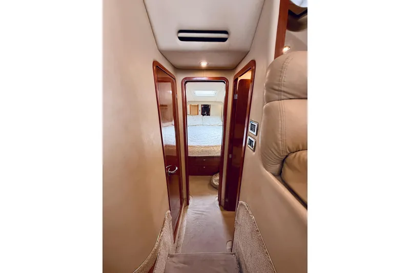 Slide: The Image of Interior hallway of 2003 Sea Ray 480 Motor Yacht, featuring elegant wood finishes and cozy cabin access. - 46