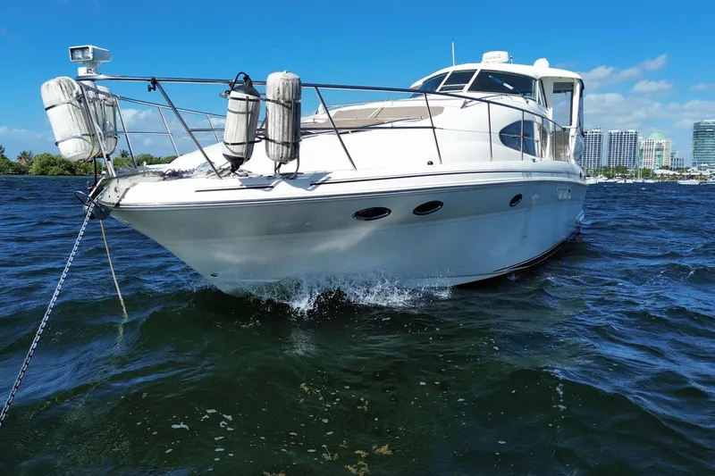 Slide: The Image of 2003 Sea Ray 480 Motor Yacht cruising on blue water under clear sky. - 16