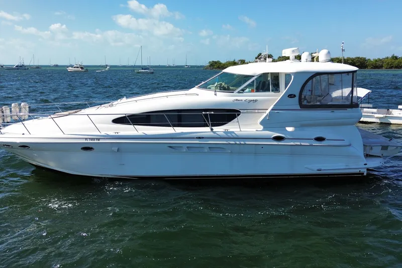 Slide: The Image of 2003 Sea Ray 480 Motor Yacht on calm waters, showcasing sleek design and luxury features. - 2