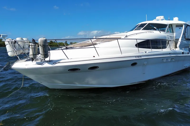 Slide: The Image of 2003 Sea Ray 480 Motor Yacht on water, sunny day, blue sky background. - 11