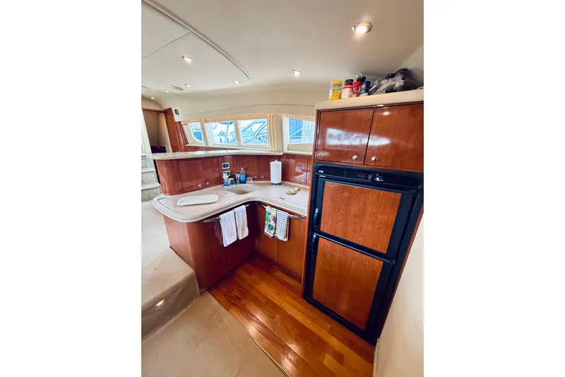 Slide: The Image of Luxurious 2003 Sea Ray 480 Motor Yacht kitchen with wood cabinetry and modern appliances. - 45