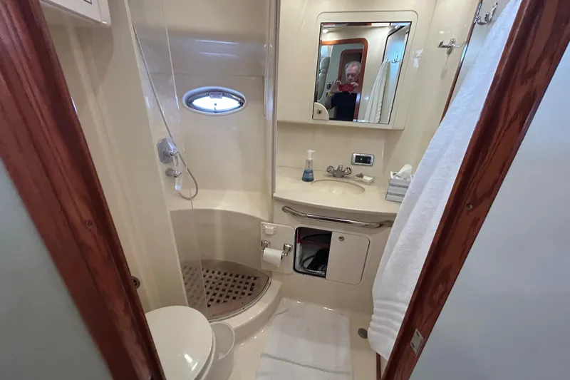 Slide: The Image of Bathroom interior of 2003 Sea Ray 480 Motor Yacht, featuring shower, sink, and mirror. - 48