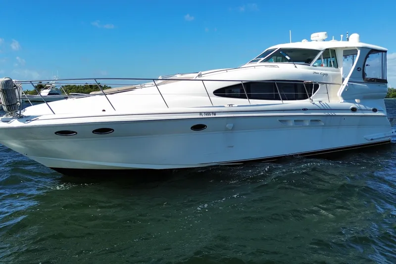 Slide: The Image of 2003 Sea Ray 480 Motor Yacht on water, sleek design, sunny day. - 13
