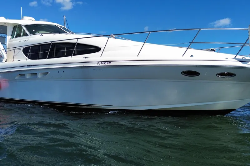 Slide: The Image of 2003 Sea Ray 480 Motor Yacht on water, showcasing sleek design and white exterior. - 10