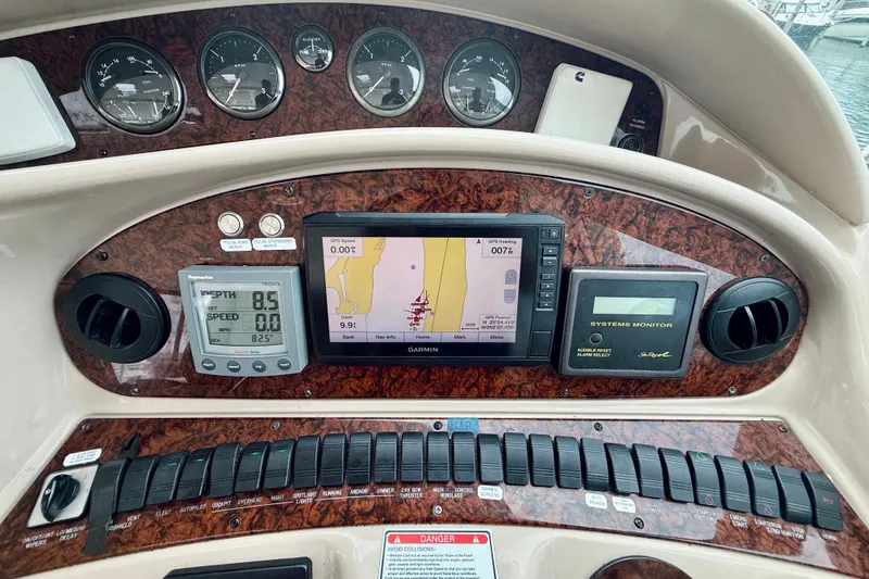 Slide: The Image of Control panel of a 2003 Sea Ray 480 Motor Yacht with navigation and monitoring systems. - 34