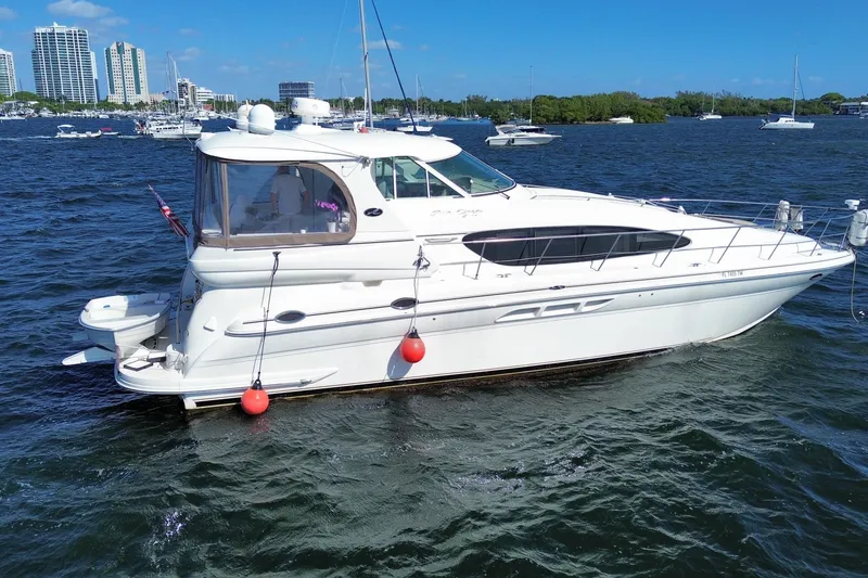Slide: The Image of 2003 Sea Ray 480 Motor Yacht on water with city skyline background. - 6