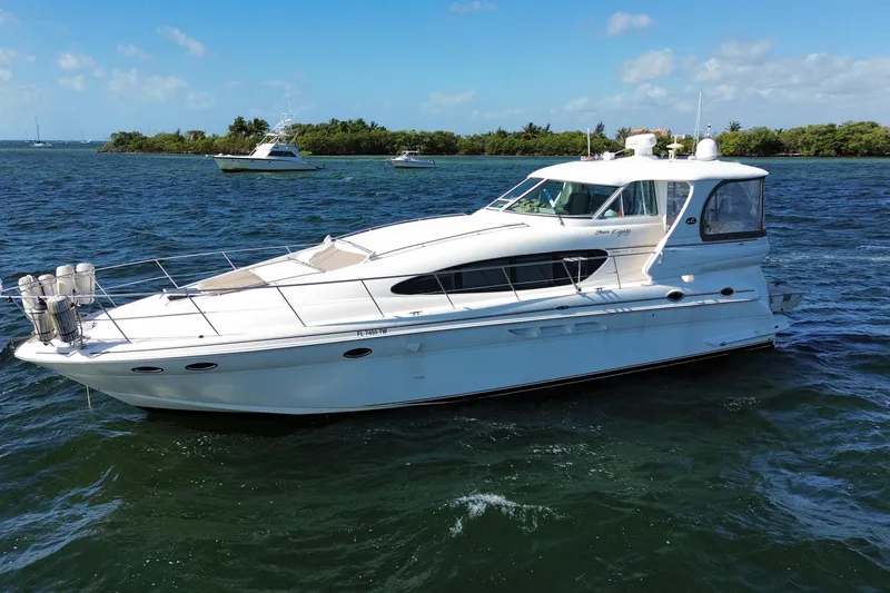 Slide: The Image of 2003 Sea Ray 480 Motor Yacht cruising on a sunny day, surrounded by blue waters. - 9