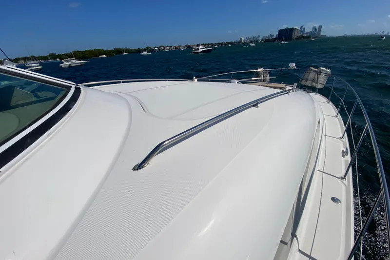 Slide: The Image of 2003 Sea Ray 480 Motor Yacht cruising on a sunny day with city skyline in background. - 24