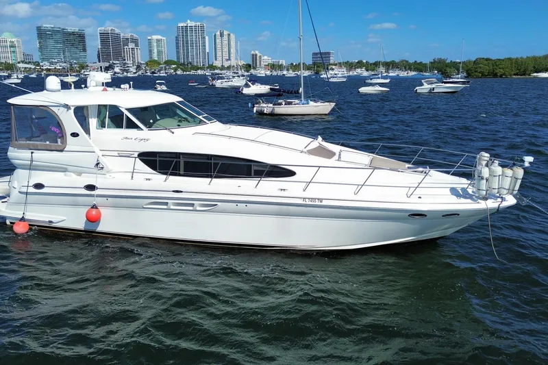 Slide: The Image of 2003 Sea Ray 480 Motor Yacht on water with city skyline in background. - 3