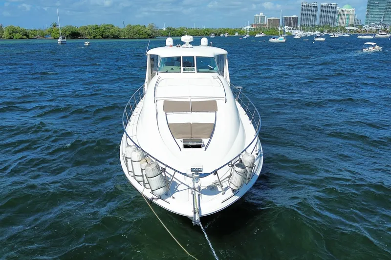 Slide: The Image of 2003 Sea Ray 480 Motor Yacht anchored on blue water with city skyline in background. - 8