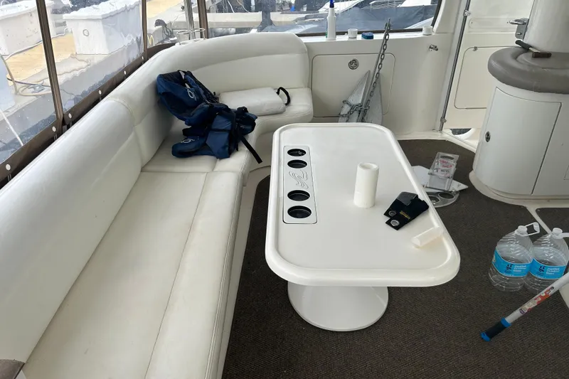 Slide: The Image of Interior of 2003 Sea Ray 480 Motor Yacht with seating and table setup. - 32