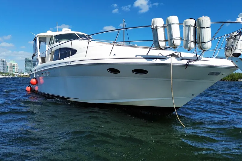 Slide: The Image of 2003 Sea Ray 480 Motor Yacht on water, sunny day, city skyline background. - 12