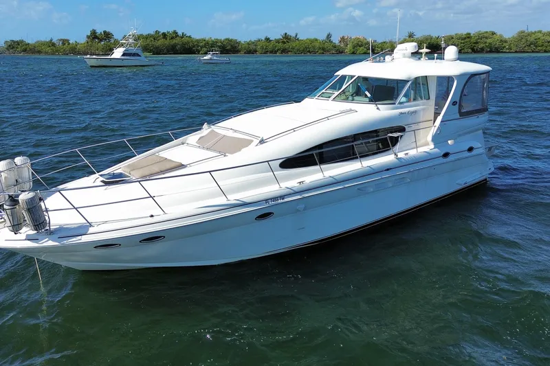 Slide: The Image of 2003 Sea Ray 480 Motor Yacht on calm waters with scenic background. - 7