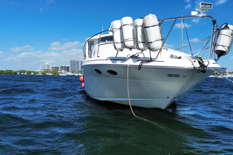 Slide: The Image of 2003 Sea Ray 480 Motor Yacht on water, city skyline in background, sunny day. - 14