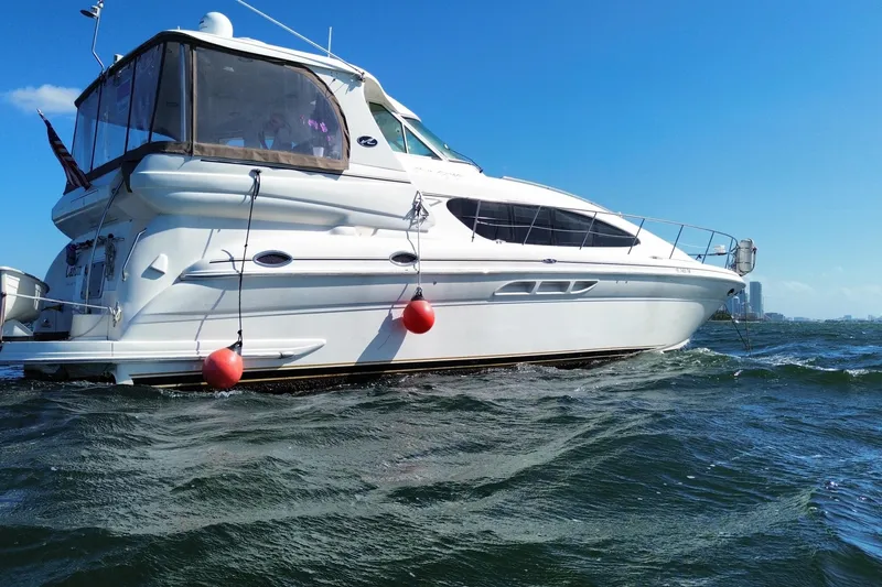Slide: The Image of 2003 Sea Ray 480 Motor Yacht on water, clear sky background. - 20