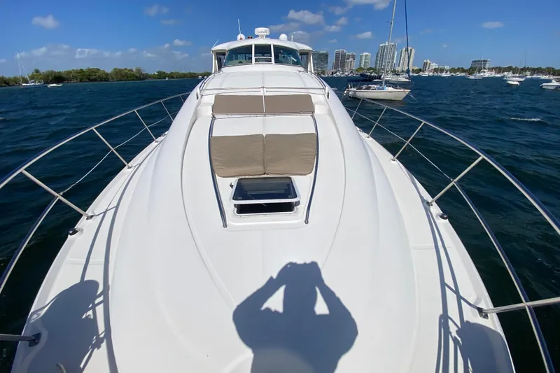 Slide: The Image of 2003 Sea Ray 480 Motor Yacht on water with city skyline in background. - 29