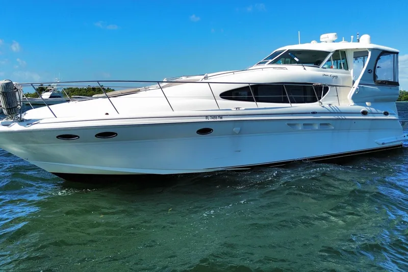 Slide: The Image of 2003 Sea Ray 480 Motor Yacht cruising on clear blue waters. - 15