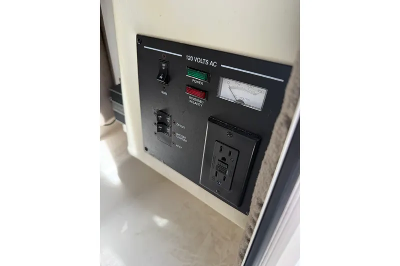 Slide: The Image of Control panel of a 2006 Sea Ray 270 SLX boat with 120 volts AC outlet. - 13