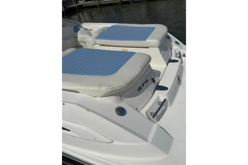 Slide: The Image of 2006 Sea Ray 270 SLX boat with blue cushioned seating on deck. - 8