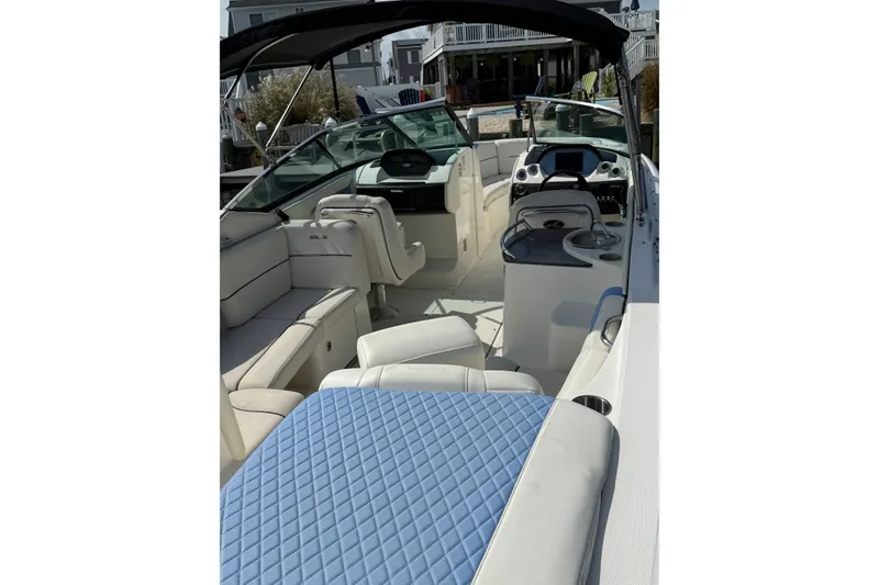 Slide: The Image of 2006 Sea Ray 270 SLX boat interior with white seating and blue accents. - 1