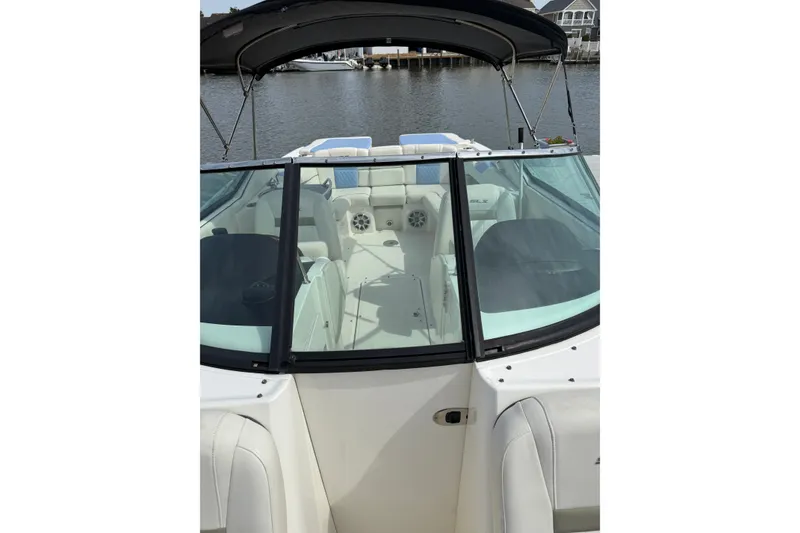Slide: The Image of 2006 Sea Ray 270 SLX boat with open cockpit and black canopy on calm water. - 4