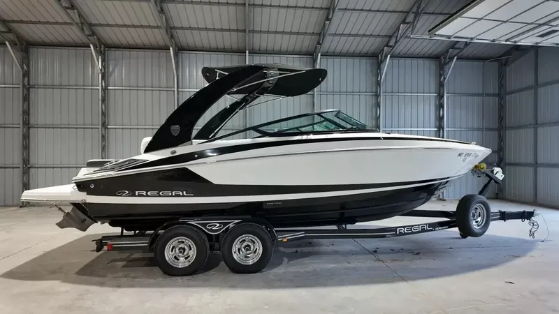 The Image of A 2017 Regal 2300 Bowrider on a trailer inside a storage facility. - 1