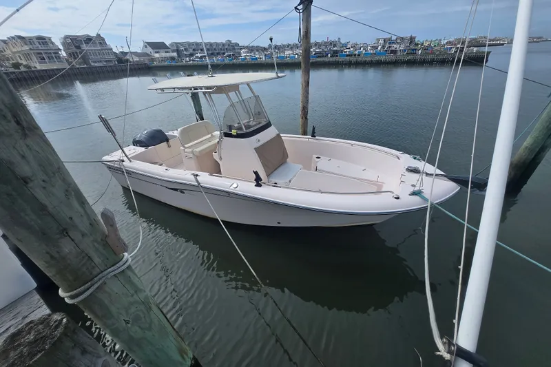 Slide: The Image of 2014 Grady-White Fisherman 230 boat docked in a marina, calm water, clear sky. - 2