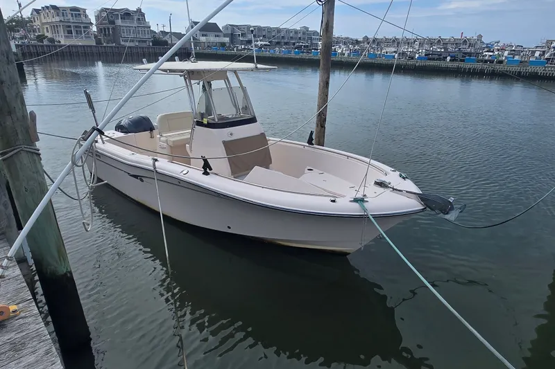 Slide: The Image of 2014 Grady-White Fisherman 230 boat docked in a marina with waterfront homes. - 1