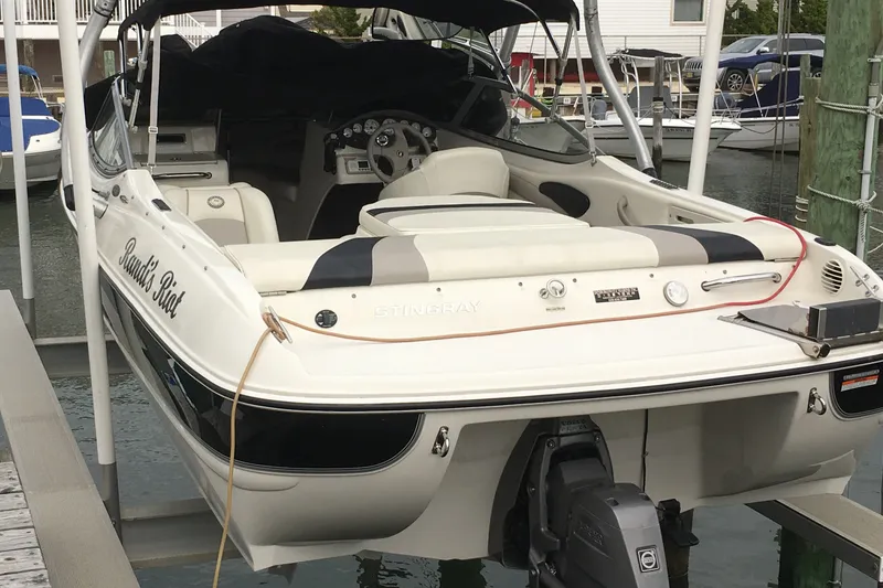 Slide: The Image of 2012 Stingray 195 LS/LX boat docked, featuring sleek design and comfortable seating. - 3