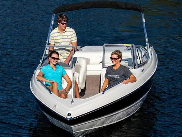 Slide: The Image of Manufacturer Provided Image: 2013 Stingray 195 LS/LX boat with three people enjoying a ride on the water. - 8