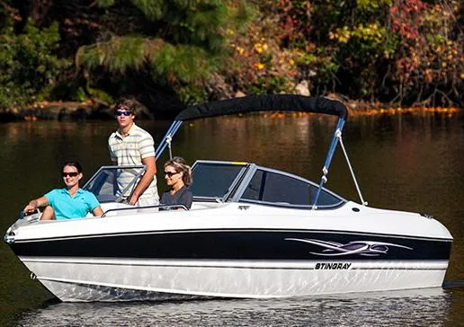 Slide: The Image of Manufacturer Provided Image: 2013 Stingray 195 LS/LX boat with three people cruising on a calm lake. - 7