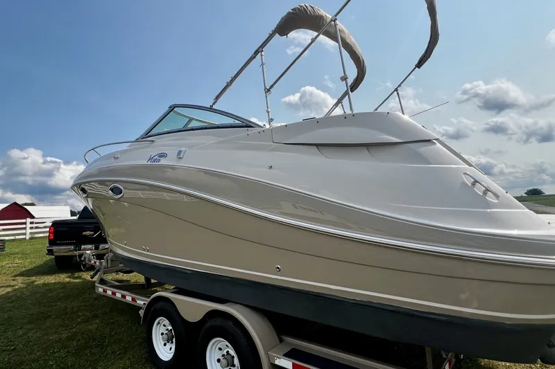 Slide: The Image of 2007 Four Winns 288 Vista boat on trailer, parked outdoors under a cloudy sky. - 7