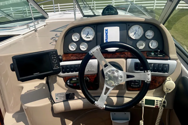 Slide: The Image of 2007 Four Winns 288 Vista boat dashboard with steering wheel and navigation instruments. - 13