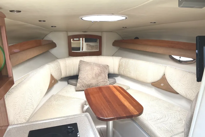 Slide: The Image of Luxurious interior of 2007 Four Winns 288 Vista boat with elegant seating and wooden table. - 19