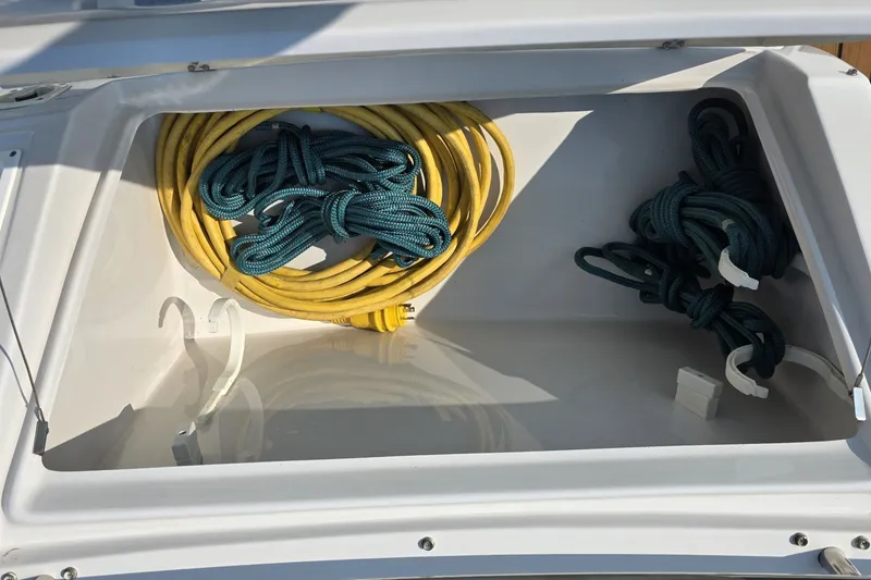 Slide: The Image of Storage compartment of 2007 Four Winns 288 Vista boat with coiled ropes. - 26
