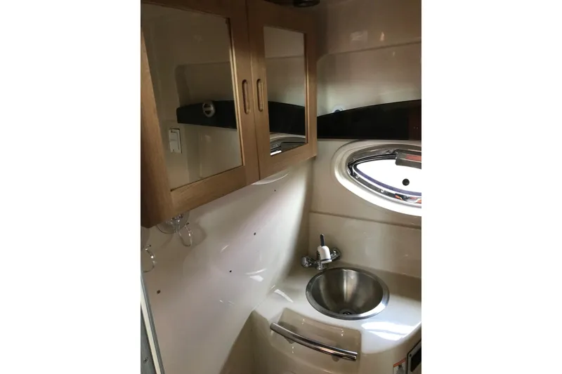 Slide: The Image of 2007 Four Winns 278 Vista boat interior with sink and wooden cabinets. - 25