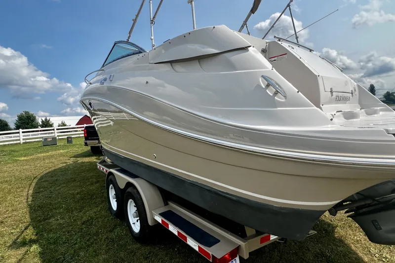 Slide: The Image of 2007 Four Winns 288 Vista boat on trailer, displayed outdoors under a partly cloudy sky. - 8