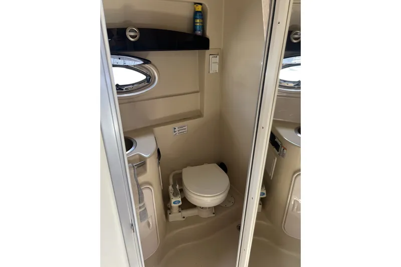 Slide: The Image of 2007 Four Winns 288 Vista boat bathroom with toilet and porthole window. - 21